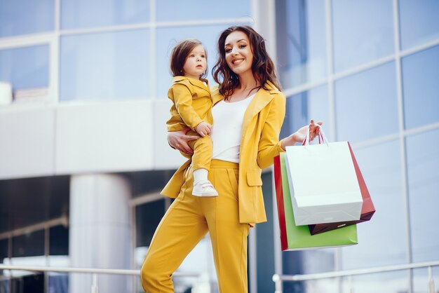 Mother and daughter with shopping bag in a city