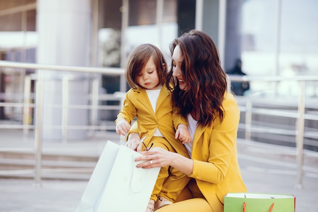 Mother and daughter with shopping bag in a city