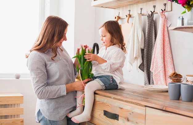 Mother and daughter with tulip flowers