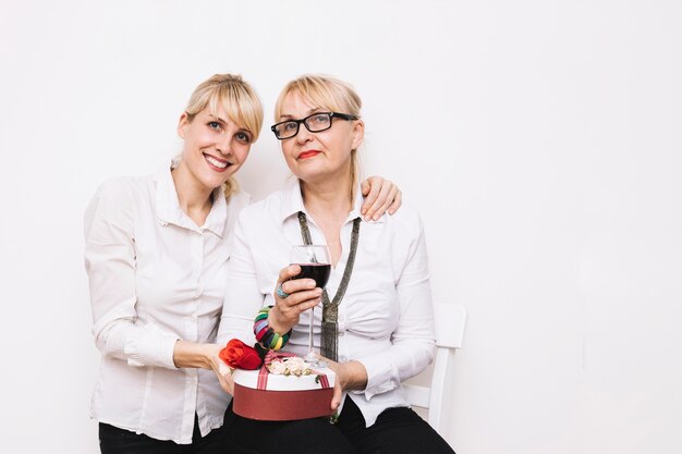 Mother and daughter with wine and present