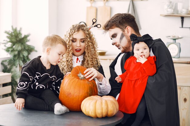 Free photo mother father and children in costumes and makeup. family prepare to celebration of halloween.