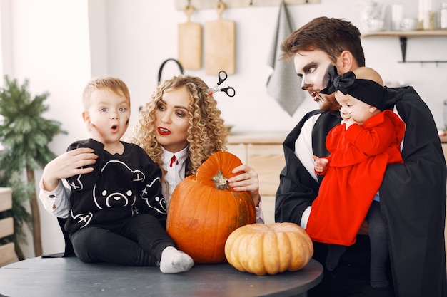 Free photo mother father and children in costumes and makeup. family prepare to celebration of halloween.