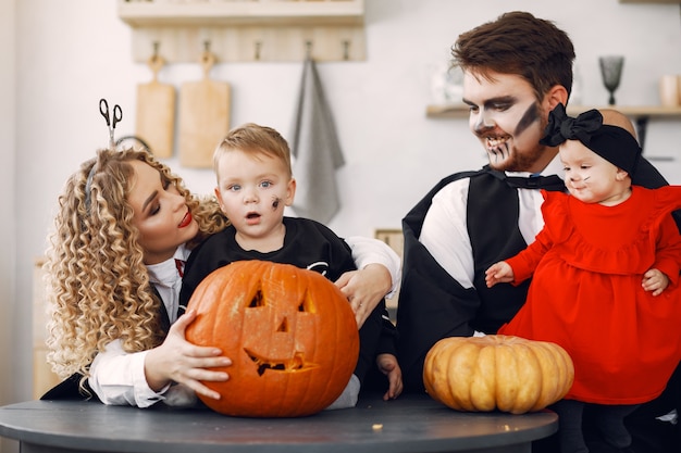 Free photo mother father and children in costumes and makeup. family prepare to celebration of halloween.