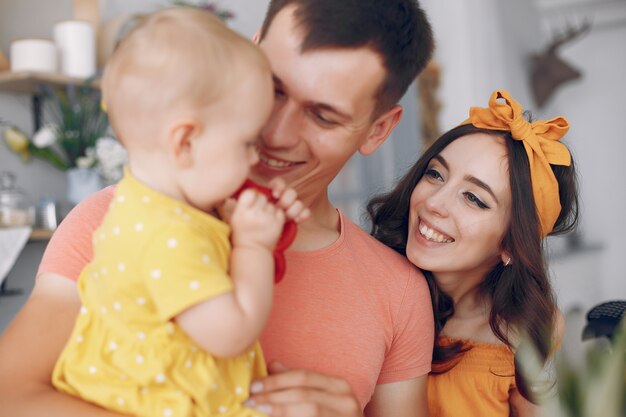 Mother and father feed their daughter a pepper