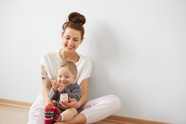 Mother feeding her baby boy with spoon