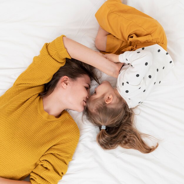 Mother and girl in bed