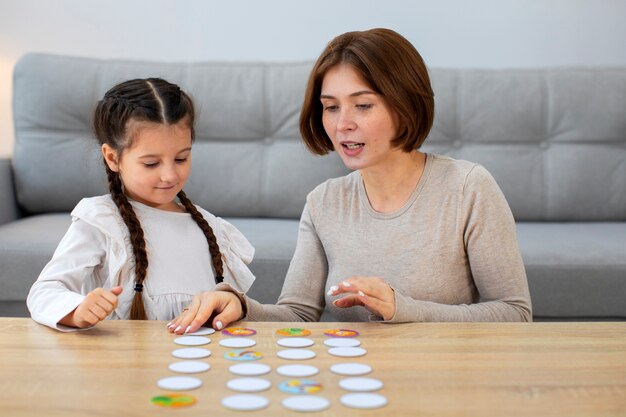 Mother and girl playing game front view