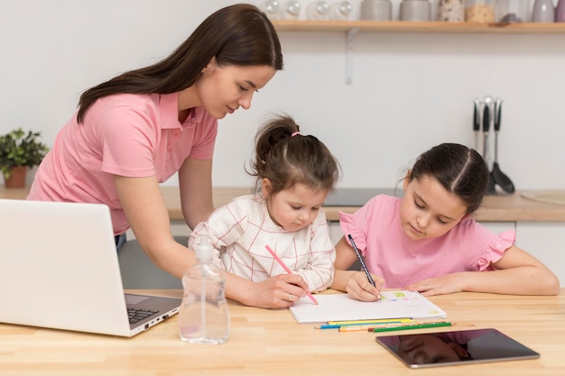 Mother and girls colouring