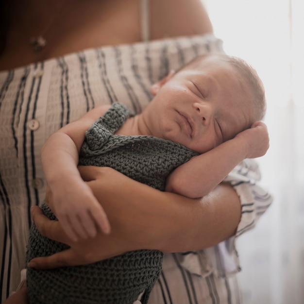 Free photo mother hand holding cute little baby