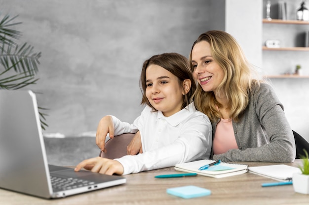 Mother helping daughter to study