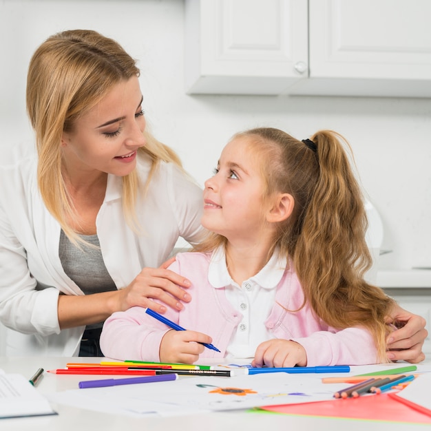 Mother helping daughter with her homework