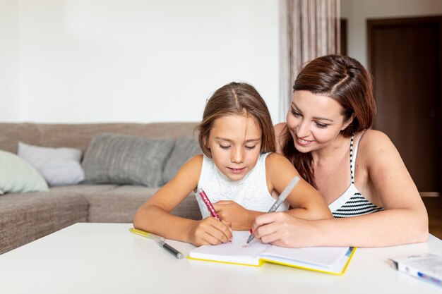 Mother helping her daughter do her homework