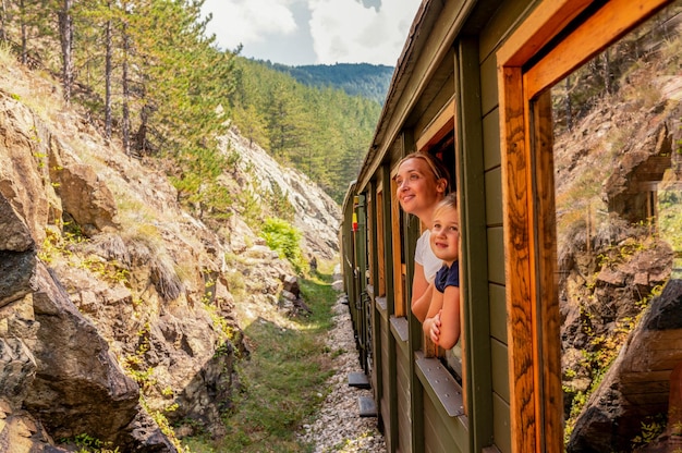 Free photo mother and her child looking out the window of a train