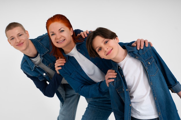 Free Photo mother and her two sons wearing denim outfits together