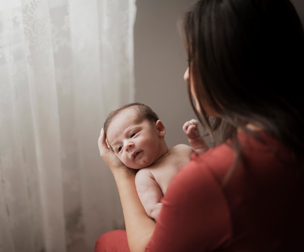 Mother holding adorable little baby