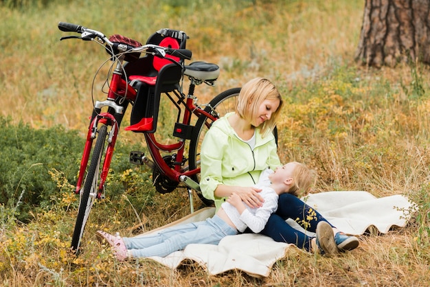 Mother holding daughter on lap