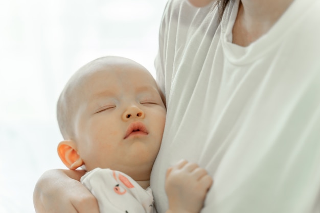 Mother holding sleeping baby