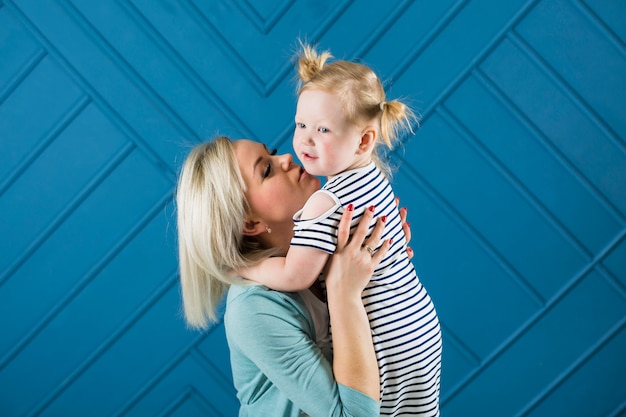 Free Photo mother hugging and kissing daughter