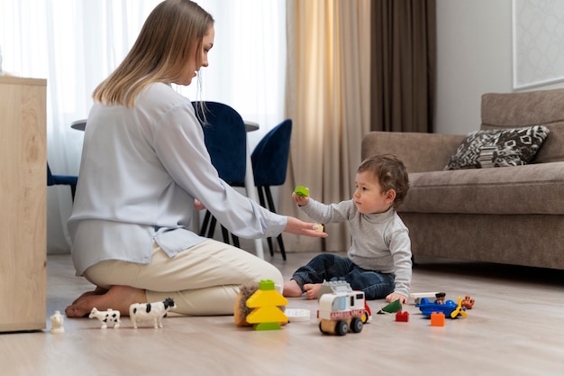 Mother and kid playing with toys full shot