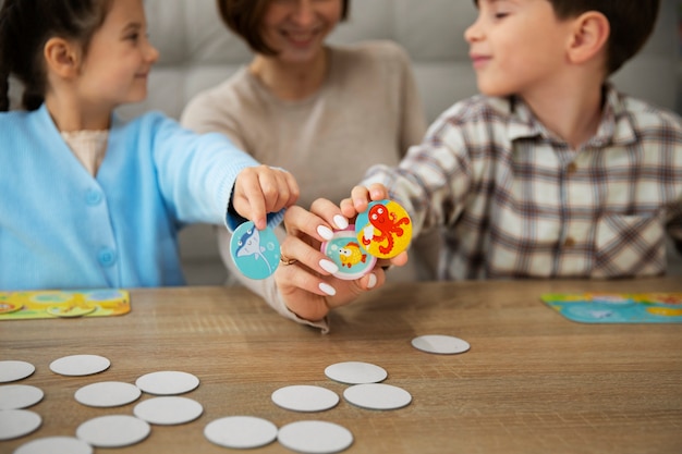 Mother and kids playing memory game front view