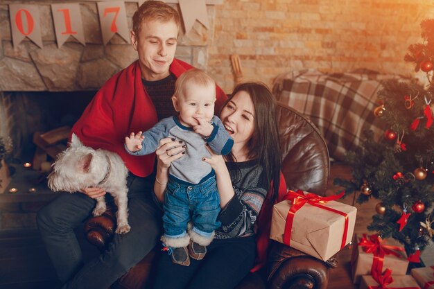 Mother lifting baby up while father holds dog on knees