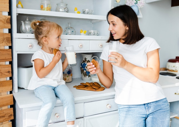 Mother and little daughter drinking milk