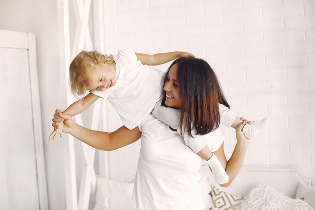 Mother and little daughter have fun at home