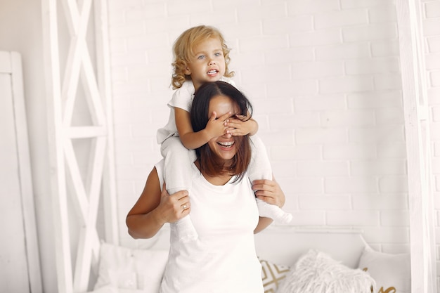 Mother and little daughter have fun at home