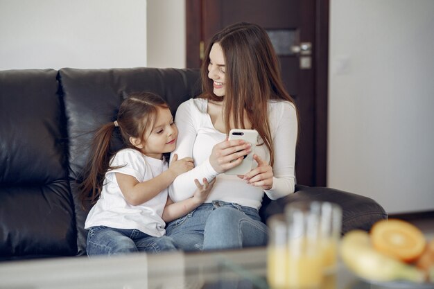 Mother and little daughter have fun at home