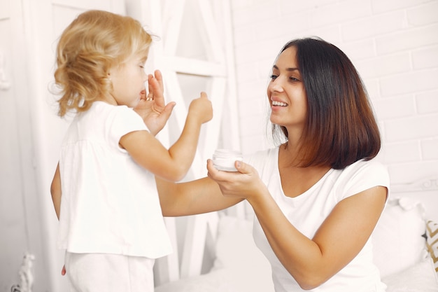 Mother and little daughter having fun at home