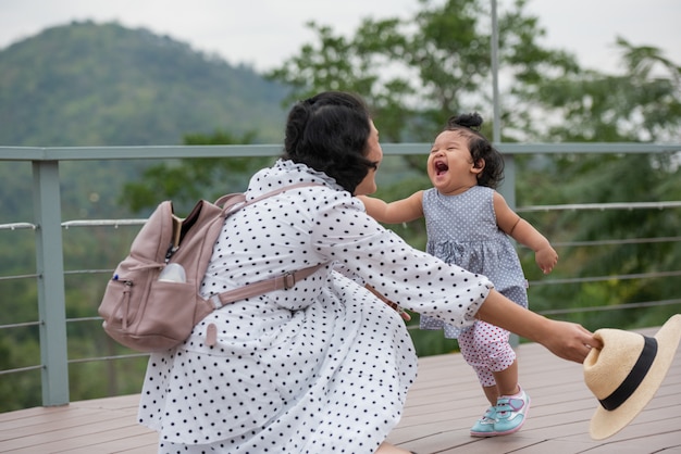 mother and little daughter playing together in a park