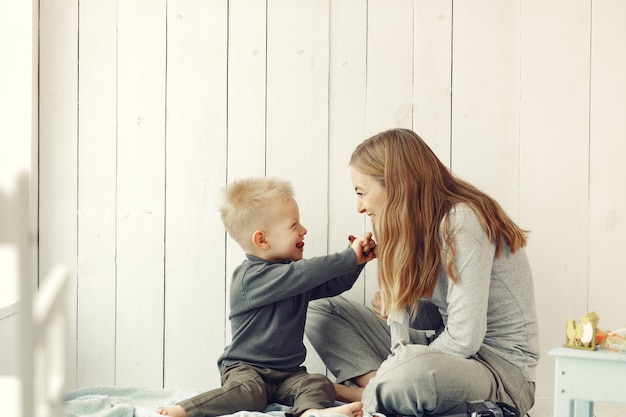 Mother and little son playing at home