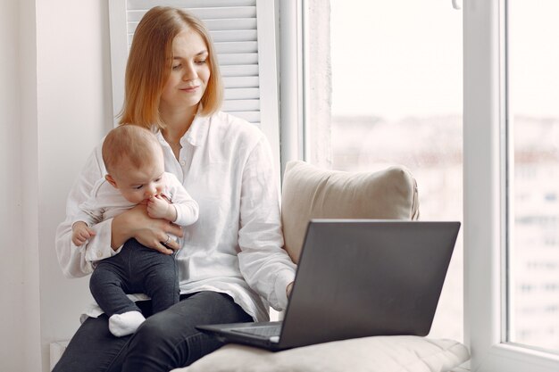 Mother and little son sitting on a windowsill