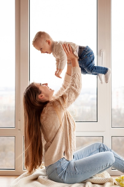 Free photo mother playing with little son