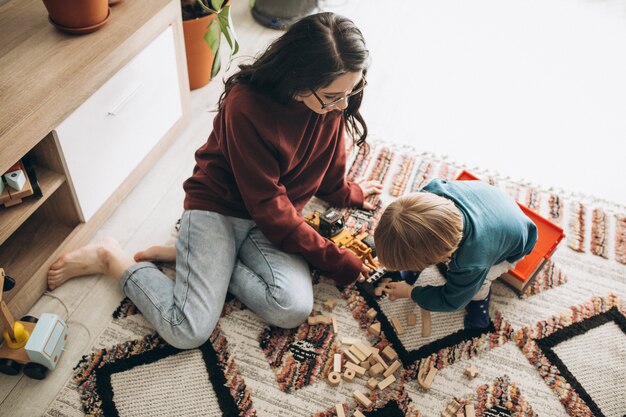 Mother playing with son at home