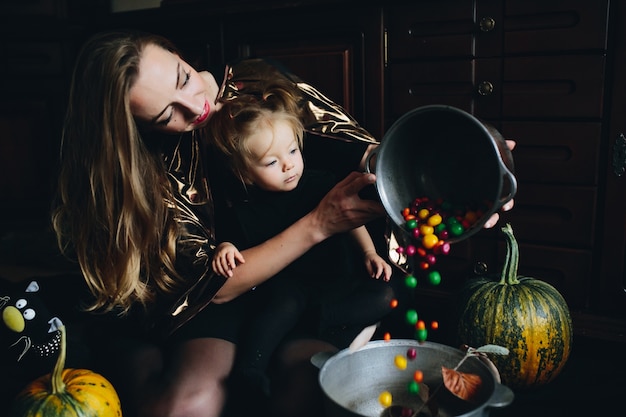 Mother pouring candies into a bowl