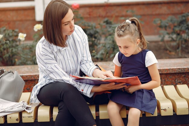 Mother prepare little daughter to school