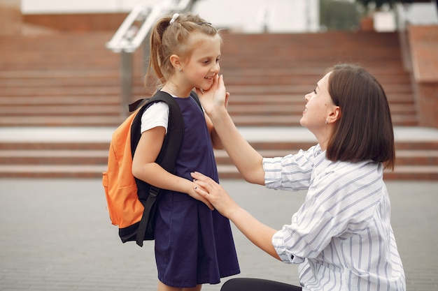 Mother prepare little daughter to school