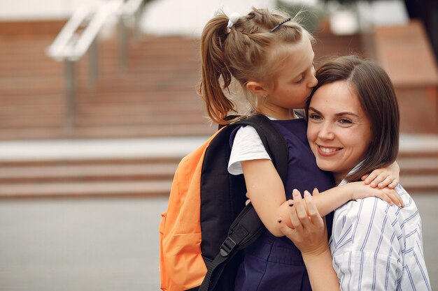 Mother prepare little daughter to school