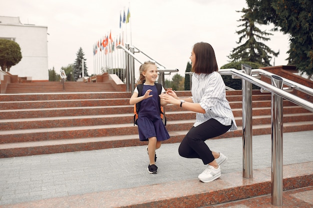 Free photo mother prepare little daughter to school