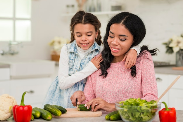 Mother preparing food for daughter