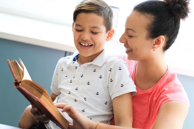 Mother reading a book to her little son