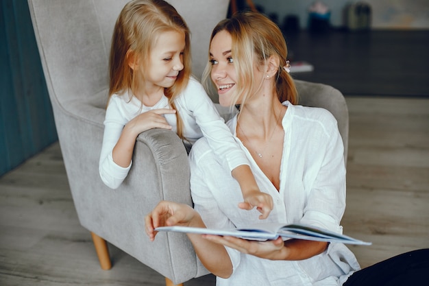 Free photo mother reading a book with daughter