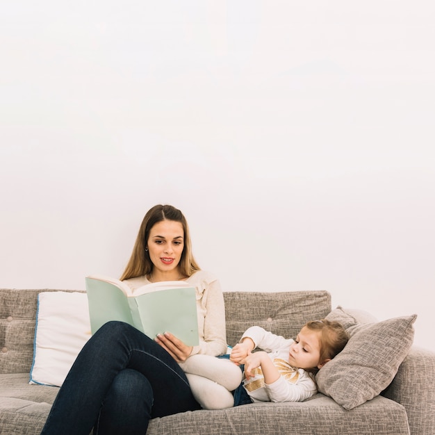 Mother reading story to daughter