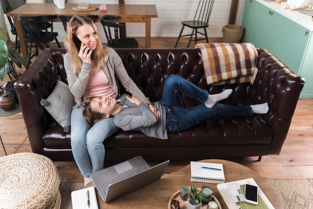 Mother relaxing together with son on the couch