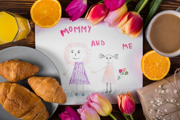 Free photo mother`s day drawing around flowers and breakfast