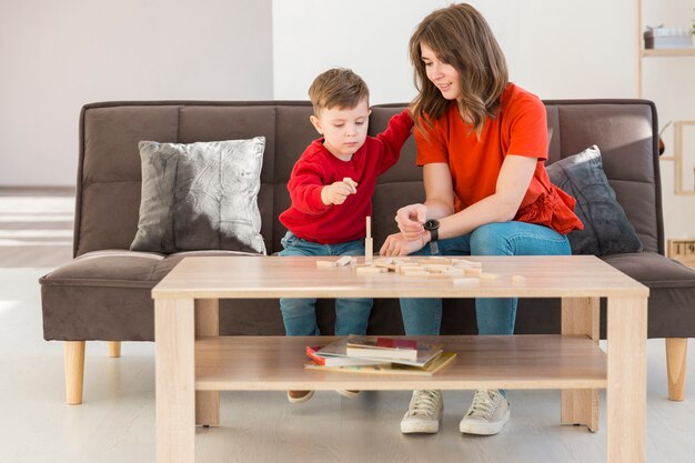 Mother and son at home playing janga game