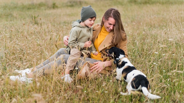 Mother and son looking at a cute dog