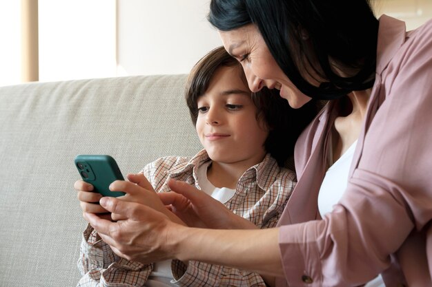 Mother and son looking together on a smartphone