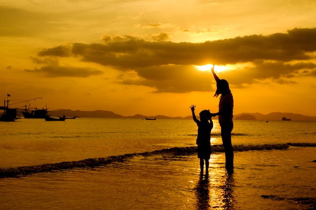 A mother and son in outdoors at sunset with copy space